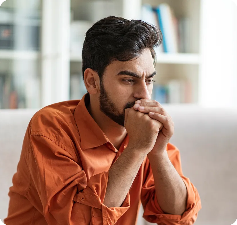 Man with hands clasped, worried – online psychiatry in Portland, OR